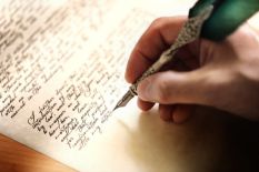 person-writing-letter-with-metal-quill.jpg